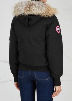 Invest in an outerwear staple beloved by the fashion set with this arctic white Chilliwack parka. Inspired by the bomber jackets of Canada's post-war bush pilots, it's designed with durability, warmth and mobility in mind; heavy-duty shell is packed with heat-trapping down and slicked with a water-resistant finish, while the short length allows for ease of movement. Finally, its removable coyote fur collar is both stylish and softly insulating.Designer ID: 7999LColour code: 61Composition:  85% polyester, 15% cotton; filling: 80% down, 20% feathers; lining: 100% polyamide, fully linedWashing instructions: dry clean Canada Goose Women Outfits, Canada Goose Chilliwack, Canada Goose Parka, Canada Goose Women, Canadian Goose, Coyote Fur, Colour Code, Down Parka, Bomber Jackets