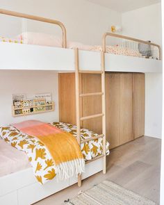 a bedroom with two bunk beds and a rug on the floor