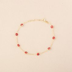 Our 14K Gold Evil Eye Bracelet is a blend of style and symbolism, inspired by the cultural heritage of the Turkish evil eye. This dainty bracelet, available exclusively in gold, features a choice of a blue or red evil eye charm, each known for its protective properties and cultural significance. The bracelet's delicate cable chain, with a thickness of 0.85 mm, is perfect for a subtle yet fashionable look and ideal for layering with other pieces. The adjustable length, ranging from 6.3" to 7.5", ensures a comfortable and versatile fit for various wrist sizes. Key Features: Cultural Symbol: Features a blue or red Turkish evil eye charm, known for its protective qualities and cultural significance. Delicate Design: Crafted with a slender cable chain, perfect for layering and versatile styling Red Symbolic Bracelet Jewelry, Symbolic Red Bracelet Jewelry, Minimalist 14k Gold Red Bracelets, Minimalist Red 14k Gold Bracelets, Minimalist Red 14k Gold Bracelet, Gold-plated Yellow Gold Evil Eye Bracelet, 14k Gold Bracelets With Evil Eye, Red 14k Gold Dainty Bracelet, Red Evil Eye Jewelry