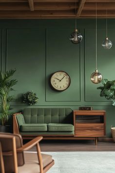 a living room with green walls and two hanging clocks on the wall, one large clock mounted to the wall