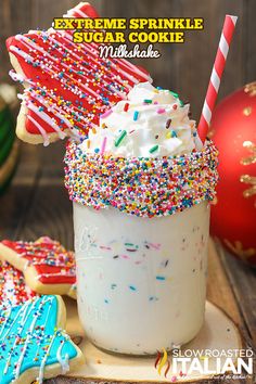 an image of a drink with sprinkles and cookies on the table in front of it