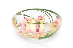 a glass bowl filled with pink and yellow flowers