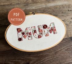 the word mum is made out of flowers and has been stitched into an embroidery pattern