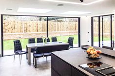 an open kitchen and dining room with sliding glass doors