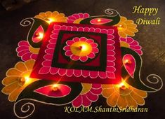 happy diwali with lit candles on the ground in front of an artistic design