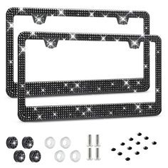 two black and white license plates with screws, nuts and washers on them