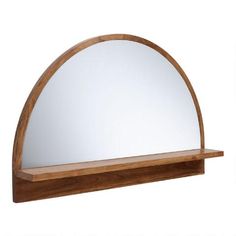 a wooden shelf with a mirror on it