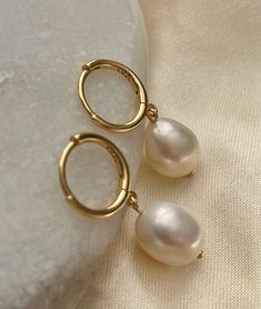 ❀Pearl❀ Earrings  Dress your ears in pure elegance with our Gold-Plated Sterling Silver Freshwater Pearl Drop Earrings! 🌟✨ Delicate and dainty, these beauties add a touch of sophistication to any look. The lustrous pearls dance with every step, making you the star of the show. Shine on, you glamorous pearl lover!   ♥ One pair   ♥ Gold Plated Sterling Silver   ♥ One Freshwater pearls on each earring  ♥ Total length approx. 2.8cm   All Freshwater Pearls vary slightly in size and shape  Keep your sterling silver stunners shining like the stars they are! ✨ Here's the 411: *Wear Often: Yep, you read it right! Regular wear helps prevent tarnish. *Avoid Sweat & Sprays: Take off your silver babes before hitting the gym or spraying on perfume. They like to keep it dry. *Store Smart: Pop them in a Pearl Drop Earrings Aesthetic, Gold Drop Pearl Earrings, It Girl Earrings, Gold Earrings With Pearls, Classic Pearl Hoop Huggie Earrings, White Pearl Huggie Hoop Earrings, Elegant White Huggie Hoop Earrings, Elegant White Huggie Earrings For Everyday, Pearl Round Huggie Earrings For Gifts