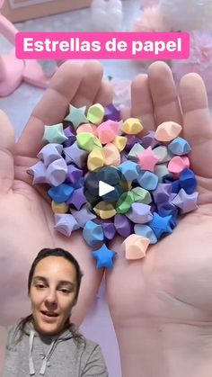 a woman is holding up some origami pieces in her hands with the caption, estrellas de papel