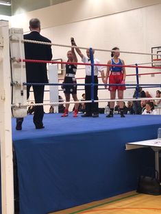 two men standing next to each other in a boxing ring