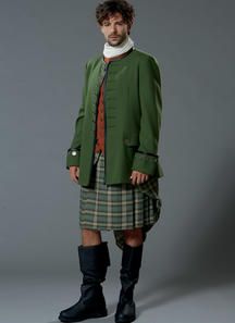 a man in a kilt and jacket posing for a photo on a gray background