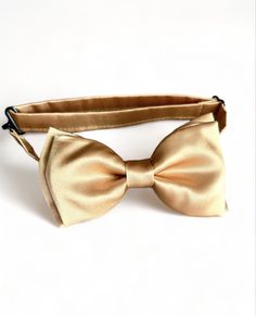 Gold satin pre- tied bow tie. Perfect for your any occasion. Please allow me 2-3 days to make your ties as I don't always have them ready to ship. If you have any questions, please message me. WEDDING ORDERS: Please let me know your wedding date to assure I can meet your deadlines. It take about 5 days to make wedding orders.  INTERNATIONAL ORDERS: Please review shipping policies as first class shipping can take up to 2-4 weeks. Gold Bow Tie Outfit Men, Pre-tied Bow Tie With Butterfly Knot As Gift, Pre-tied Butterfly Knot Bow Tie Gift, Elegant Pre-tied Bow For Gift, Classic Detachable Bow Tie For Groom, Elegant Adjustable Bow Tie For Groom, Classic Wedding Bow Tie With Bow Tie Back, Classic Pre-tied Bow For Wedding, Dapper Bow Tie For Formal Father's Day