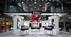 the entrance to dior's new store is decorated with pink flowers and jewelry