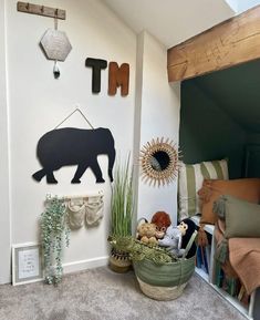 a room with stuffed animals and decorations on the wall, including a bear hanging from the ceiling