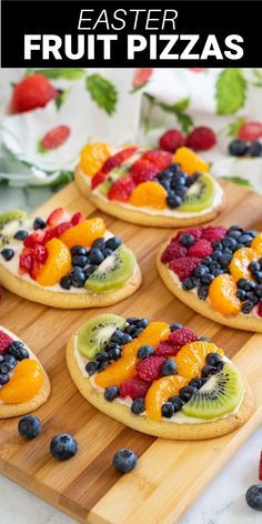 fresh fruit pizzas are arranged on a cutting board