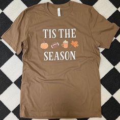 ~ Tis The Season Fall ~ Crewneck Sweatshirt  ITS BACK! And better! A best seller from last fall, this Crewneck features fall season favorites - football, leaves, coffee, and pumpkins! This year we added color to the images for some extra detail and design.  -->Item Details I offer two sweatshirt brands for this design: Gildan and Bella+Canvas.  Both are a cotton/polyester blend and a Crewneck style. Please see pictures for size/color charts and additional details.  If you have any questions, please message me 😊 Note: please keep in mind that colors may appear different on various types of digital screens and may not be an accurate representation of the true color. I try my best to capture images of the product in its truest form but due to digital screens and lighting, image colors may va Sweatshirt Brands, Fall Graphic Tees, Fall Crewneck Sweatshirt, Fall Crewneck, Fall Tshirt, Fall Graphic, Autumn T Shirts, Crewneck Style, Sweatshirt Crewneck