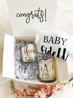 two baby gifts in a box with congratulations written on them