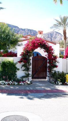 an entrance to a house with flowers on it