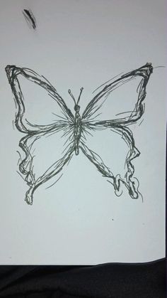 a drawing of a butterfly is shown on a piece of paper that has been drawn