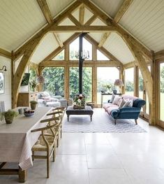 a living room filled with furniture and lots of windows