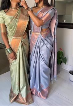 two women standing next to each other in sari