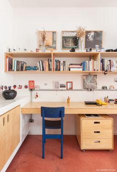 a desk with a chair and bookshelf above it