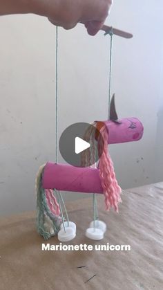 someone is making a pink toy horse out of yarn