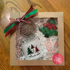 a christmas gift box with cookies, coffee mug and candy cane