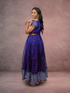 Indulge in elegance with our EthnoChic collection. This full-length Anarkali dress, featuring half sleeves crafted from luxurious Mangalagiri silk, exudes sophistication. The striking purple checkered pattern, adorned with a shimmering gold border, adds a touch of opulence to any occasion. Elevate your festive wardrobe with this timeless piece, designed for those who appreciate refined style. Dry cleaning is recommended for best care. Key Specifications : Material Mangalagiri Silk Occasion Festi Silk Anarkali, Gold Border, Full Length Dress, Anarkali Dress, Indian Ethnic Wear, Checkered Pattern, Leggings Shop, Anarkali, Purple Dress