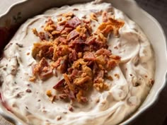 a white bowl filled with cream cheese and bacon