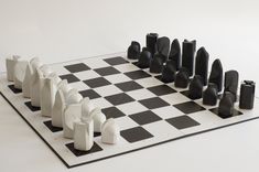 a chess board with black and white pieces on it's sides, all in the same pattern