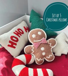 a set of 5 christmas pillows with gingerbread man and candy cane on the bed