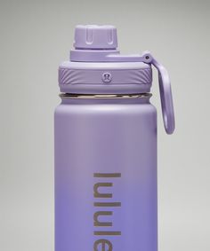 a purple insulated water bottle sitting on top of a table