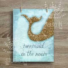 a card with a gold glitter mermaid tail on it and the words mermaid in the room