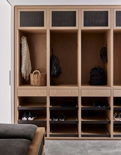 an instagramted photo of a wooden locker with shoes and bags on the shelves