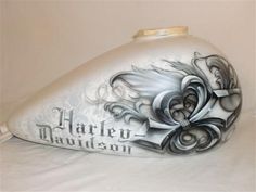 a white and black motorcycle helmet with the words harley davidson on it's side