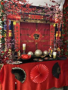 a red table topped with lots of decorations