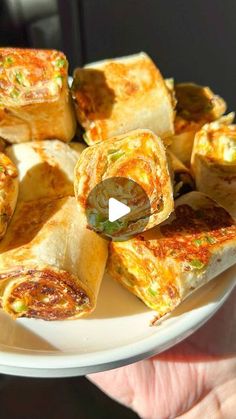 someone holding a white plate with food on it and the text, how to make egg rolls