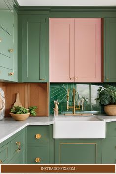 a kitchen with green and pink cabinets, white counter tops and gold pulls on the faucet