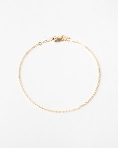 "A whisper, not a shout. Add a dainty flash of gold to your everyday look with this tiny, shiny anklet. Add a few meaningful charms or personalized disks for a look that's all yours!  Every piece is handcrafted and hand-personalized with love in La Conner, WA, using 90% recycled and 100% ethically sourced raw materials from the USA--because it's better that way. Includes free gift-ready packaging (featuring a care card and traditional letterpress goodies made by my dad)!  MATERIALS: * Gold = 14k Minimalist Gold Chain Anklets, Everyday Gold Chain Anklets, Elegant Gold Anklets In 14k Gold Filled, Minimalist Adjustable Chain Anklet, Minimalist Gold Anklet With Adjustable Chain, Minimalist Gold Chain Bracelet With Rolo Chain, Gold Minimalist Chain Bracelet With Rolo Chain, Minimalist 14k Gold Filled Anklet As Gift, Minimalist Gold Rolo Chain Bracelet