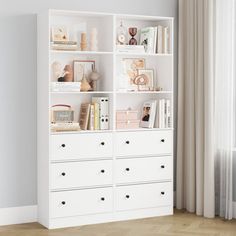 a white bookcase filled with books next to a window