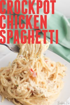 a fork full of chicken spaghetti on a white plate with the words crockpot chicken spaghetti