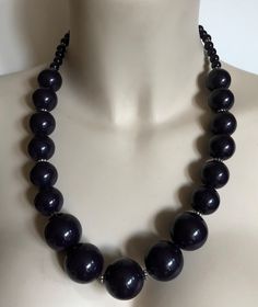 Necklace - plastic beaded necklace with large deep purple beads smaller around the neck 2nd and subsequent items of costume jewelry sent free shipping Purple Beaded Necklace With Round Black Beads, Purple Necklace With Black Beads, Purple Beaded Necklaces With Large Round Beads, Purple Large Beaded Necklace, Purple Necklaces With Polished Beads For Party, Purple Jewelry With Wooden Round Beads, Elegant Purple Necklace With Large Beads, Elegant Large Purple Beads, Purple Beaded Necklace With Large Beads For Party