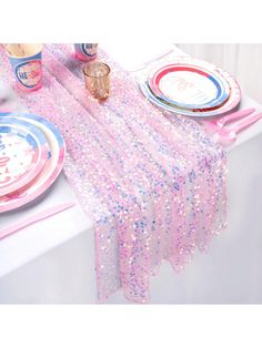 a table set with pink and blue plates