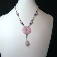 On offer is this elegant Vintage Chinese Necklace featuring a Central Round Translucent Pink Rose Quartz Circle suspended from an ornate Snail design sterling silver chain. There are hand carved Lotus design Pink Rose Quartz beads with smaller round Amethyst gems and smaller round Rose Quartz gems with a spring clasp that opens and closes tightly. There is dangling Rose Quartz Pendant that is carved into the shape of a little Monkey. The necklace measures 17 inches in length. The gems are highly Pink Beaded Amethyst Necklace, Handmade Pink Amethyst Necklace, Handmade Pink Amethyst Necklaces, Pink Amethyst Spiritual Necklace, Pink Amethyst Spiritual Necklaces, Rose Quartz Gemstone Necklaces With Round Beads, Round Purple Rose Quartz Jewelry, Purple Rose Quartz Round Jewelry, Wire Wrapped Amethyst Necklaces With Round Beads