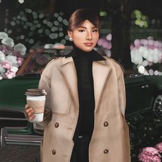 a woman holding a cup of coffee in her right hand and wearing a trench coat