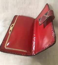 "Nice looking 1970's patch work top stitch red and black reptile leather wallet and checkbook holder. In very good vintage condition. Inside is bright red leather. Measurements are; 7\" x 3 1/4\" Feel free to convo me with any further questions. Thank you for your interest." Red Vintage Leather Wallets, Vintage Bifold Bag With Interior Card Slots, Retro Rectangular Wallet With Coin Pocket, Retro Bifold Wallets With Coin Pocket, Vintage Bifold Bags With Card Slots, Vintage Wallets With Snap Closure, Retro Leather Wallet With Coin Pocket, Vintage Red Bifold Wallet, Vintage Wallets With Snap Closure For Everyday Use