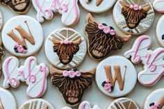 decorated cookies with the letter w on them are shown in pink, brown and white