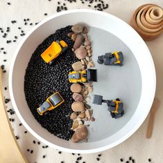 a bowl filled with rocks and toys on top of a table