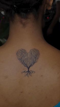 a woman with a tattoo on her back neck